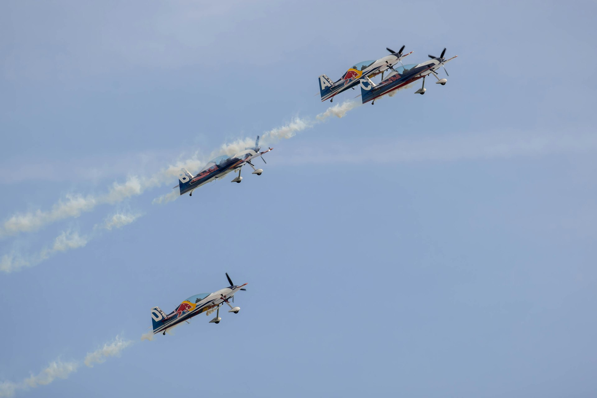 three airplanes flying in the sky with smoke coming out of them